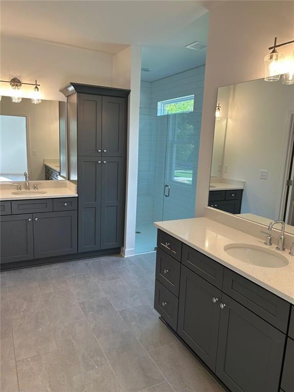 241 Saratoga Dr, Acworth, GA 30102 - bathroom featuring a shower stall and two vanities