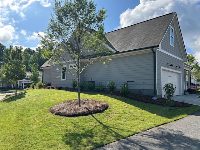 241 Saratoga Dr, Acworth, GA 30102 - view of side of property with a garage, a lawn, driveway, and a shingled roof