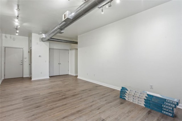 basement with hardwood / wood-style flooring