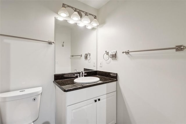 bathroom featuring toilet and vanity