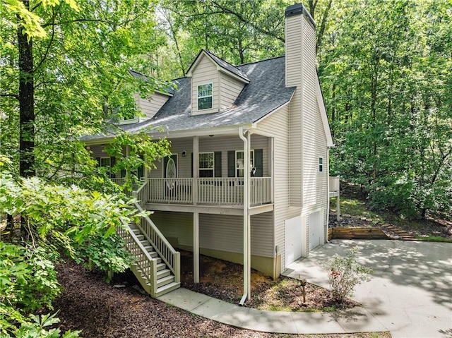 127 Walkabout Way, Dahlonega, GA 30533 - view of front of home featuring a porch, concrete driveway, stairs, a shingled roof, and a garage
