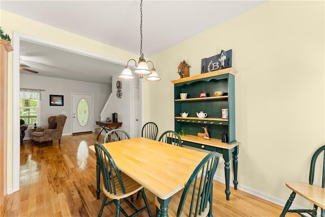 127 Walkabout Way, Dahlonega, GA 30533 - dining room with light wood-type flooring and a chandelier