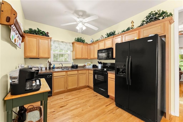 127 Walkabout Way, Dahlonega, GA 30533 - kitchen with black appliances, light brown cabinets, light wood finished floors, a ceiling fan, and dark countertops