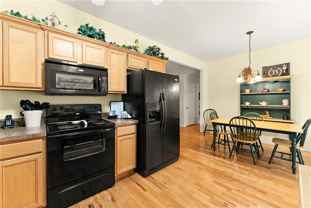 127 Walkabout Way, Dahlonega, GA 30533 - kitchen with black appliances, light wood-style flooring, light brown cabinets, and decorative light fixtures