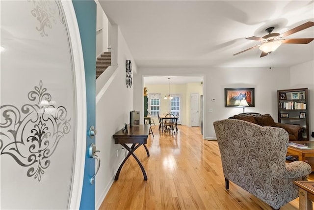 127 Walkabout Way, Dahlonega, GA 30533 - living area with light wood-style flooring, a ceiling fan, and stairway