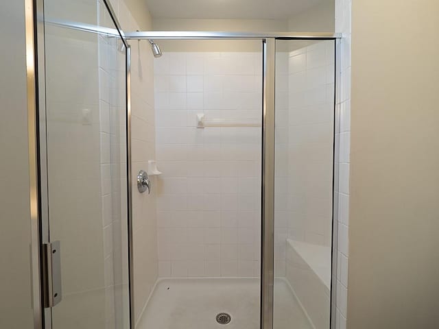 bathroom with a shower with door