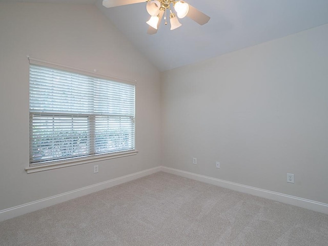 carpeted spare room featuring ceiling fan and lofted ceiling