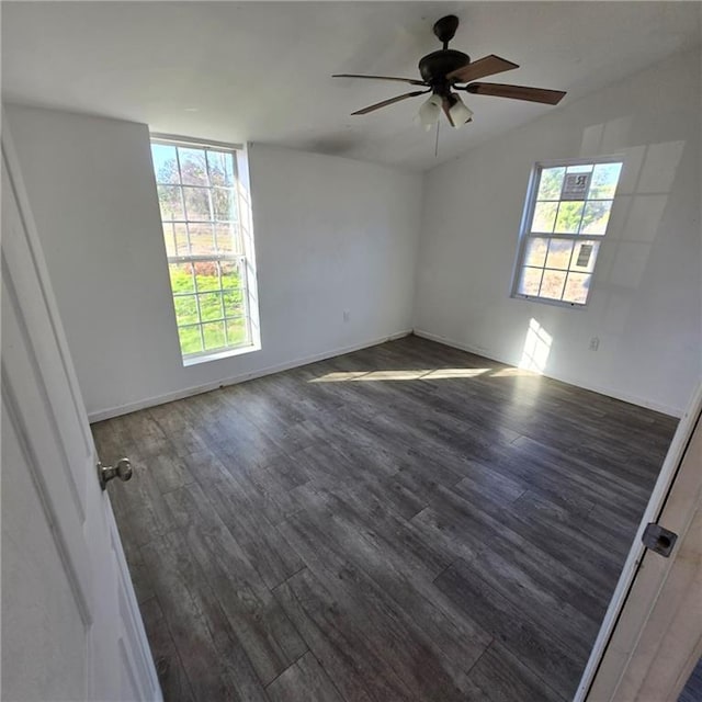 unfurnished room featuring ceiling fan, baseboards, and wood finished floors