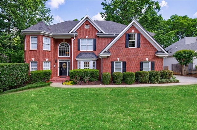 265 Dogwood Walk Ln, Norcross, GA 30071 - colonial house featuring a front lawn, brick siding, and roof with shingles