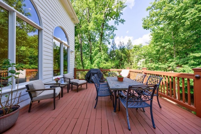 wooden deck featuring outdoor dining area