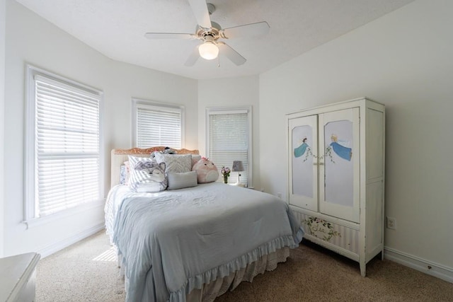 carpeted bedroom with baseboards, multiple windows, and ceiling fan