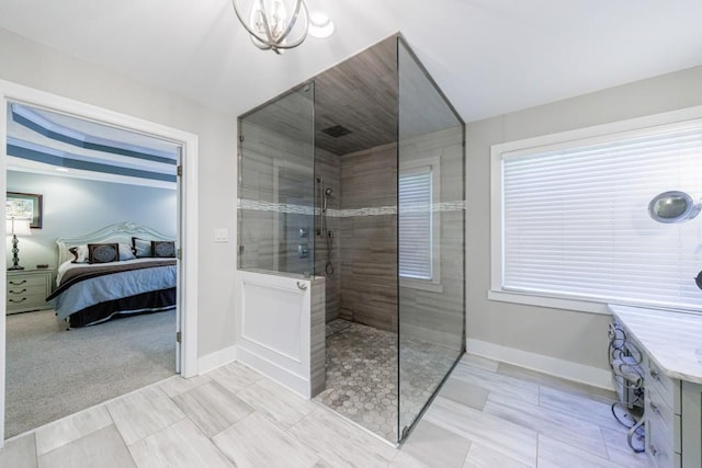 ensuite bathroom with a walk in shower, baseboards, and a chandelier