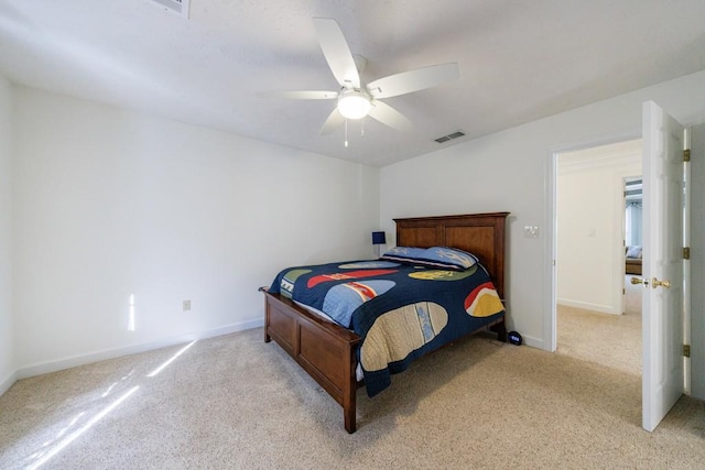 bedroom with light colored carpet, baseboards, and ceiling fan