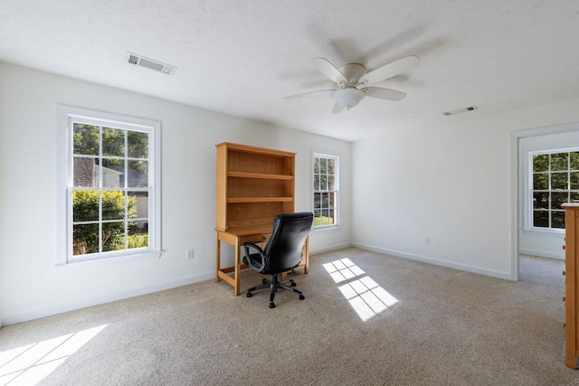 carpeted office featuring healthy amount of natural light, baseboards, and ceiling fan