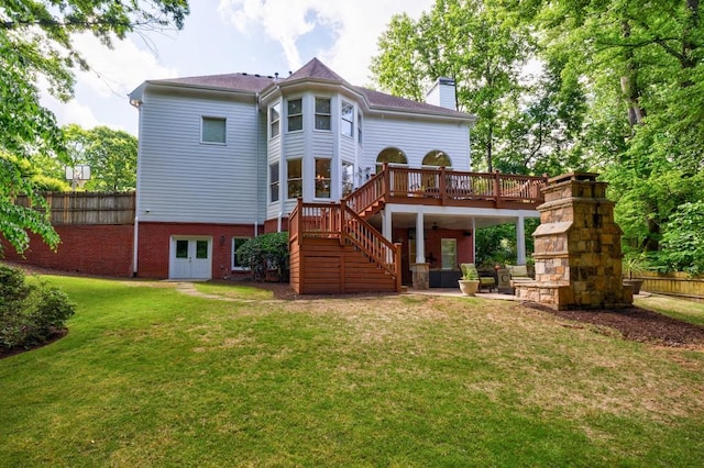 rear view of property with a chimney, a deck, stairs, and a patio