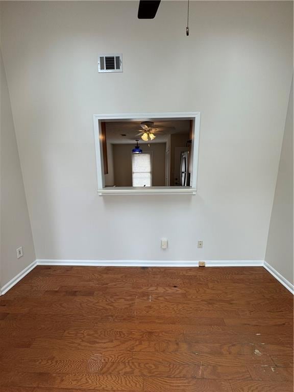 unfurnished room featuring dark hardwood / wood-style floors and ceiling fan