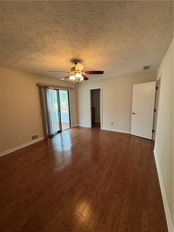 unfurnished room with ceiling fan, dark hardwood / wood-style floors, and a textured ceiling