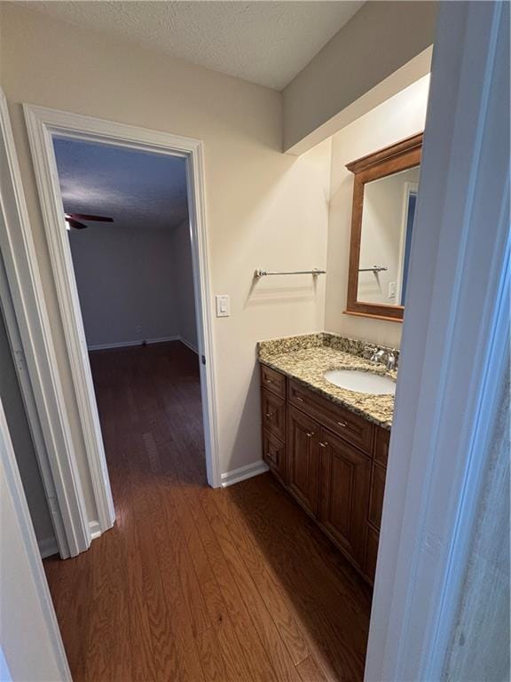 bathroom with vanity, hardwood / wood-style floors, and a textured ceiling