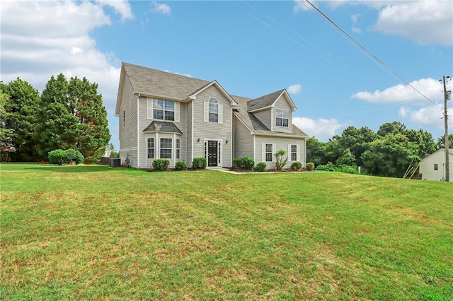 view of front of home with a front lawn and central AC unit