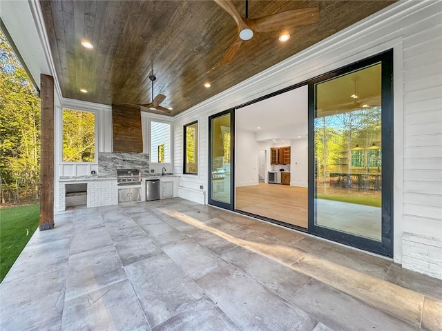 view of patio / terrace featuring an outdoor kitchen, sink, and ceiling fan