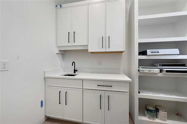 kitchen with white cabinetry and sink