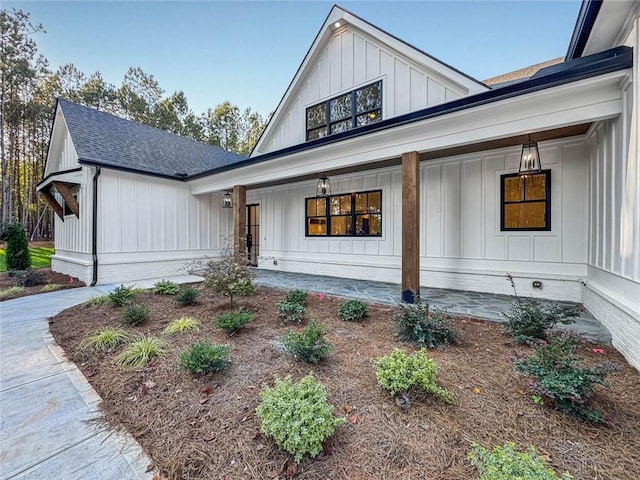 modern farmhouse style home with covered porch