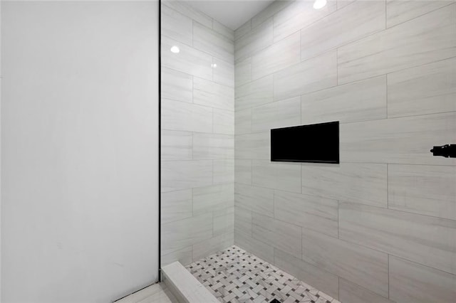 bathroom with a tile shower