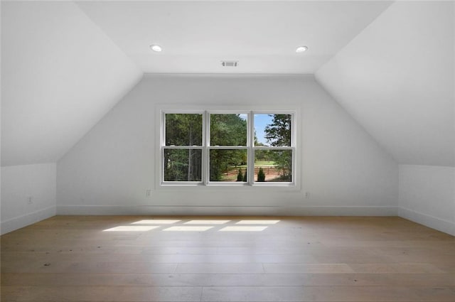 bonus room with lofted ceiling and light hardwood / wood-style flooring