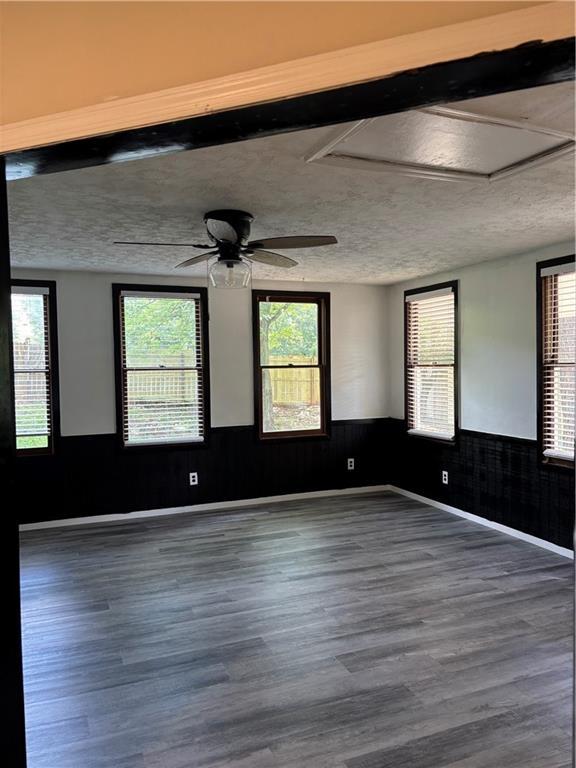 1120 Brandon Hill Way, Jonesboro, GA 30238 - unfurnished room featuring wainscoting, wood finished floors, a textured ceiling, healthy amount of natural light, and ceiling fan