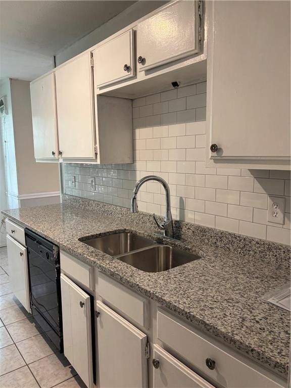 1120 Brandon Hill Way, Jonesboro, GA 30238 - kitchen featuring black dishwasher, decorative backsplash, light stone counters, and light tile patterned floors