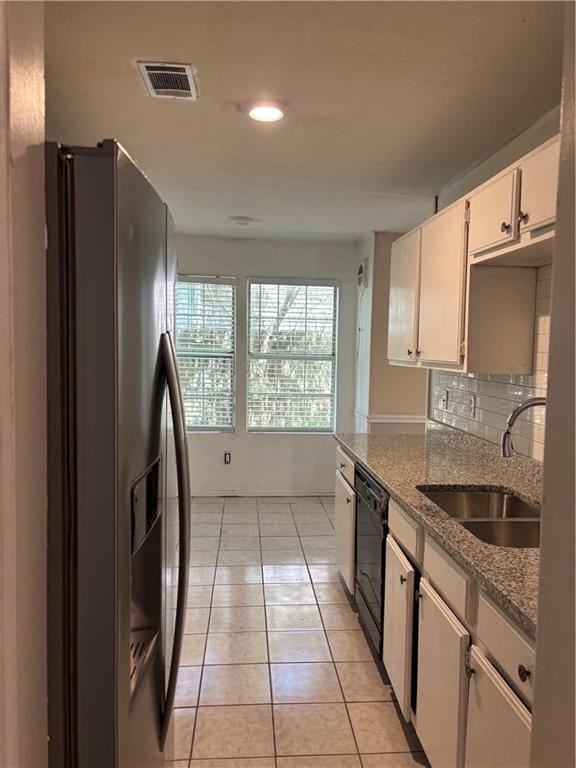 1120 Brandon Hill Way, Jonesboro, GA 30238 - kitchen with stainless steel fridge with ice dispenser, dishwasher, light tile patterned floors, light stone counters, and white cabinets