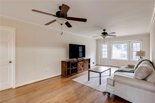 living room with baseboards, ceiling fan, hardwood / wood-style floors, and crown molding