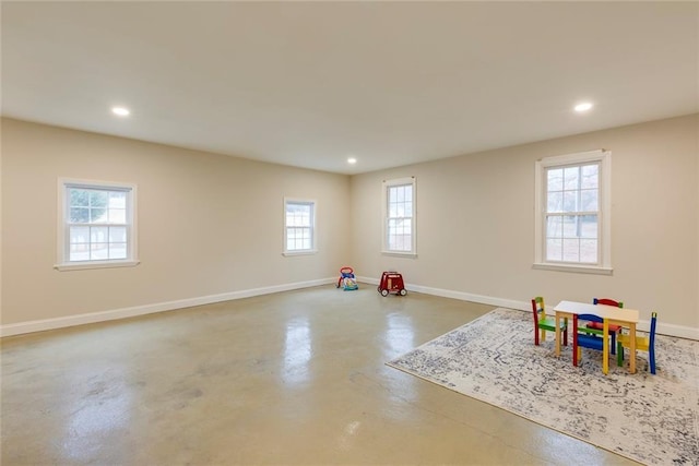 rec room with finished concrete flooring, baseboards, and recessed lighting