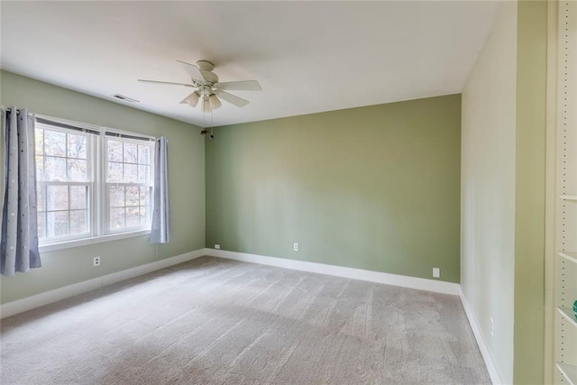 empty room with a ceiling fan, baseboards, visible vents, and carpet flooring