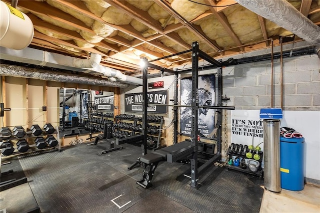 workout area featuring concrete block wall