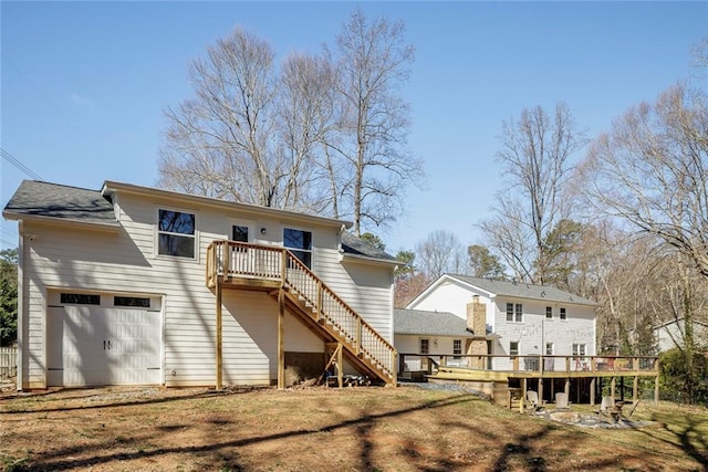 rear view of property with stairway and a wooden deck