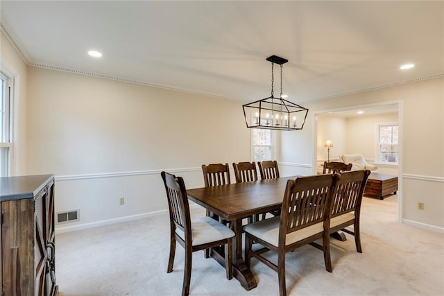 dining area featuring light carpet, baseboards, visible vents, crown molding, and recessed lighting