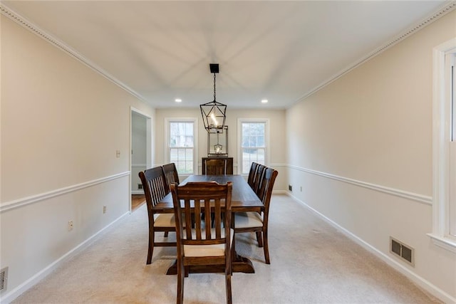 dining space with light carpet, baseboards, visible vents, and crown molding