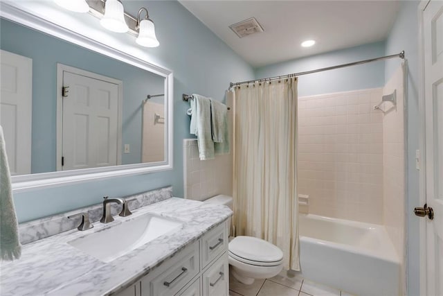 bathroom with visible vents, toilet, shower / tub combo with curtain, tile patterned flooring, and vanity