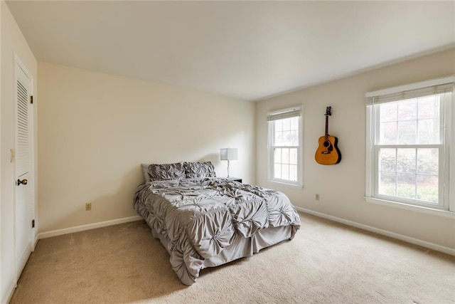 bedroom with baseboards and carpet flooring