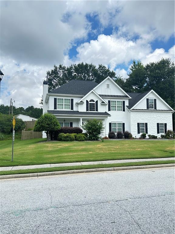 540 Langley Creek Dr, Loganville, GA 30052 - traditional-style home featuring a chimney and board and batten siding