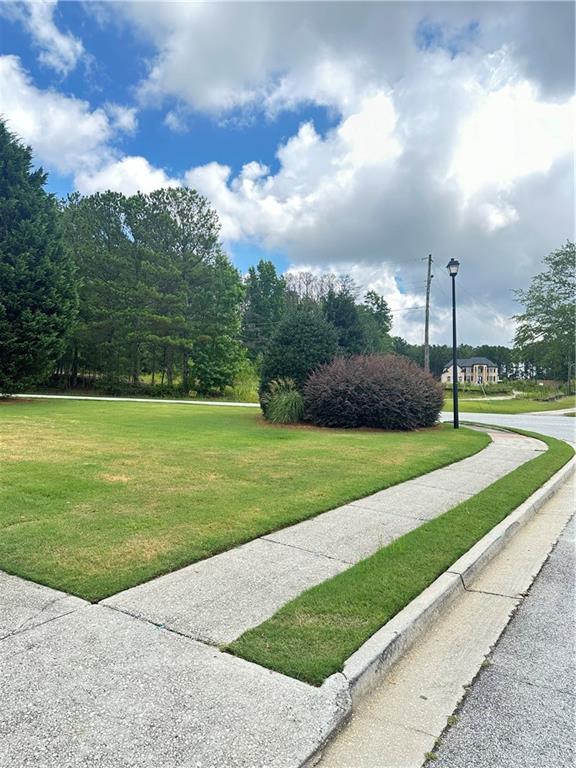 540 Langley Creek Dr, Loganville, GA 30052 - view of home's community with a lawn
