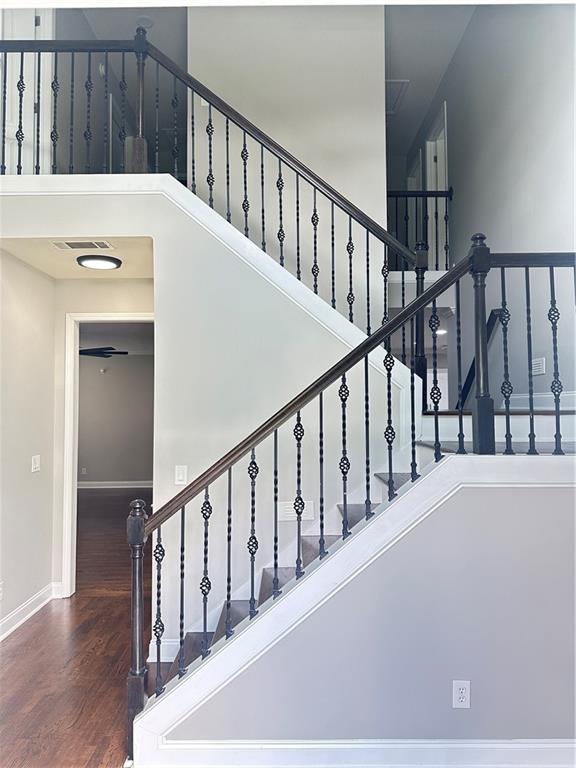 540 Langley Creek Dr, Loganville, GA 30052 - staircase with a high ceiling and wood finished floors