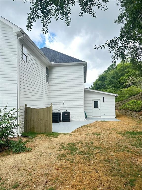 540 Langley Creek Dr, Loganville, GA 30052 - back of property with a patio area and roof with shingles