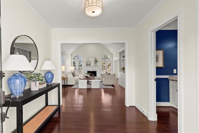 hall with crown molding, built in features, dark wood-type flooring, and vaulted ceiling