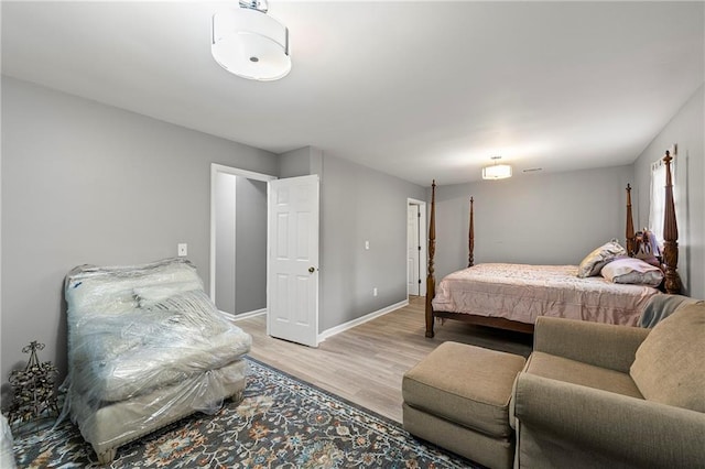 bedroom featuring light wood-style floors and baseboards