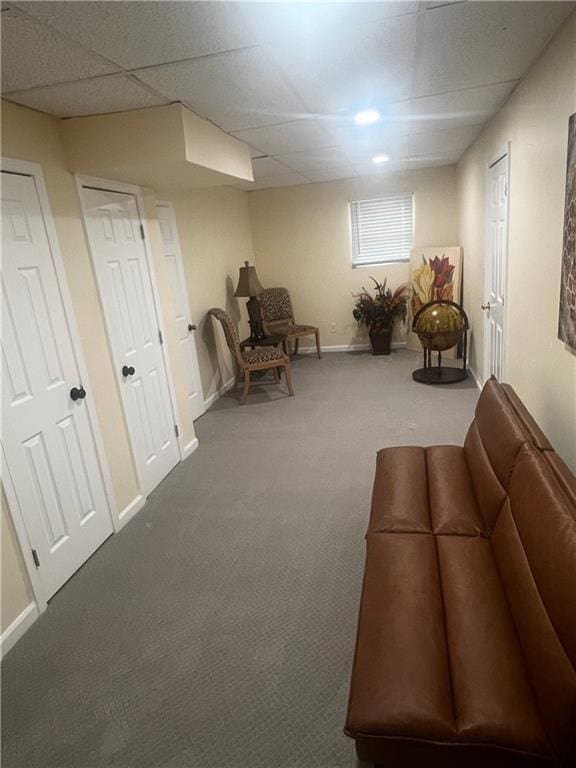 unfurnished room featuring baseboards, carpet flooring, and a drop ceiling