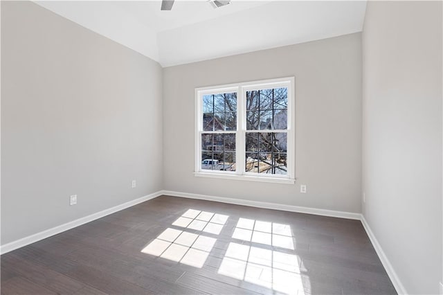 unfurnished room with lofted ceiling, dark wood-style floors, baseboards, and a ceiling fan