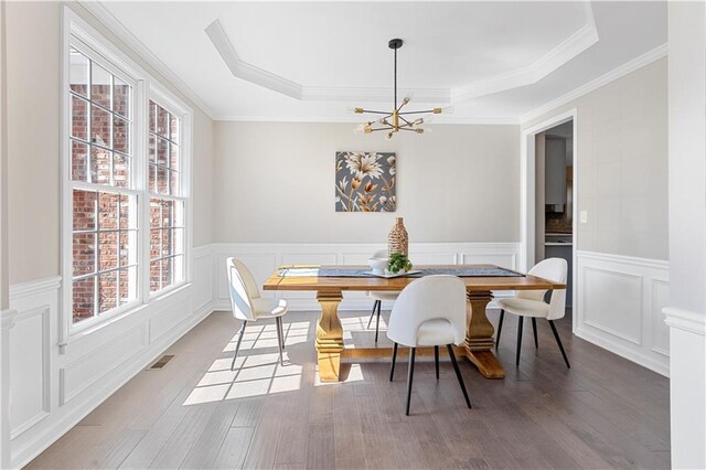 staircase with arched walkways, a ceiling fan, wood finished floors, a fireplace, and a decorative wall