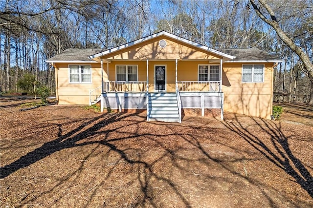 view of front of property with covered porch and stairway